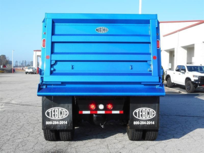 Dump truck rear showing blue bed and TEBCO mud flaps with TEBCO logo and contact number 800-284-2014.