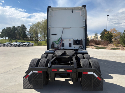 Kenworth T680 rear view showing fifth wheel, dual rear axles, and mud flaps with reflective trim.