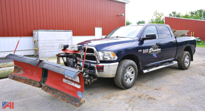 Ram 2500HD pickup with V-plow and snow spreader attached, crew cab, dark blue, side decals, front view showing plow and equipment