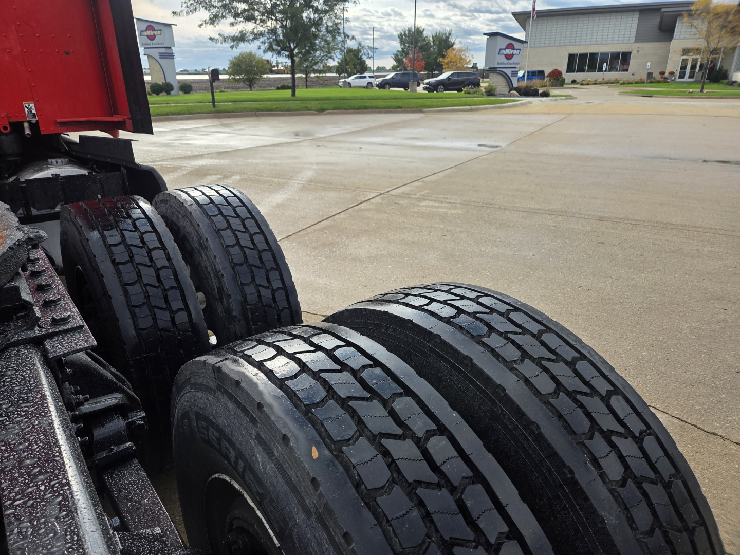 Kenworth T680 rear wheels and dual tires in the truck’s rear axle area, part of a used truck listing.