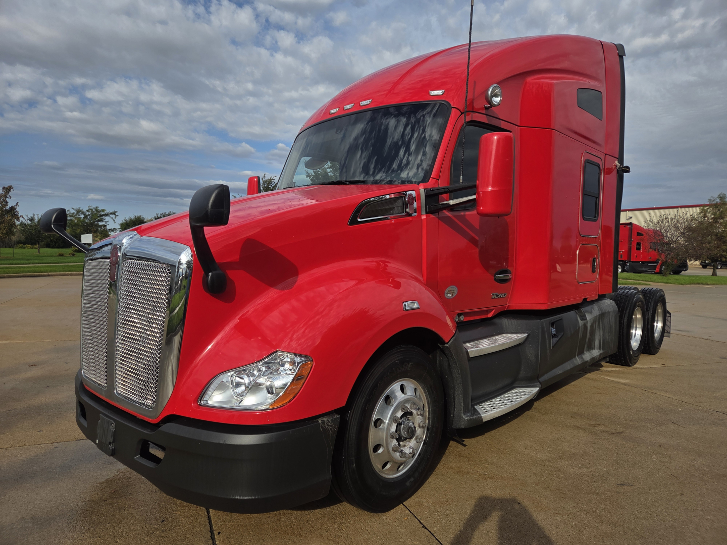 Kenworth T680 tractor-trailer in red with sleeper cab, front grille, and dual rear axles, image showing side and front view.