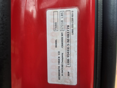 Kenworth T680 door jamb label showing model T680, gross weight 172218 LBS, VIN 1XKYD49X5NJ483778, additional ID numbers; red cab with black trim
