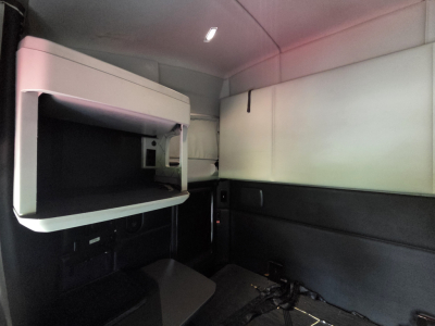 Kenworth T680 sleeper cab interior showing upper bunk area and side panels.