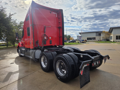 Kenworth T680 truck rear/side view showing tractor with red cab and dual rear axles.