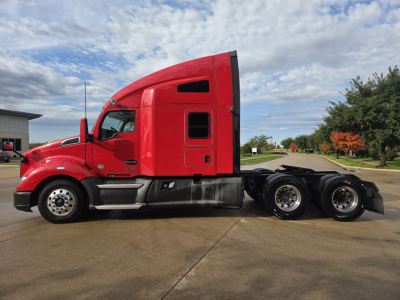 Kenworth T680 sleeper cab tractor in red side view showing rear wheels and chassis.