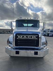 Front view of a white 2026 Mack GR64B cab and chassis truck showing large black grille with MACK letters, chrome bumper, and side mirrors.