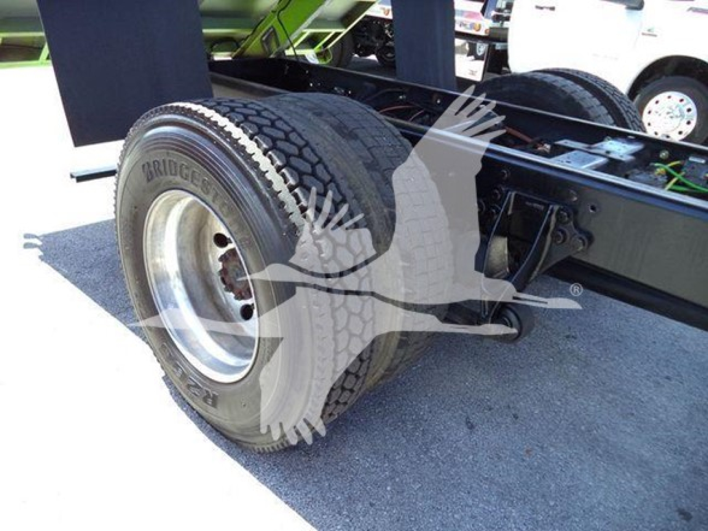 Truck rear axle and tires showing Bridgestone tires on dual rear wheels and chassis components.