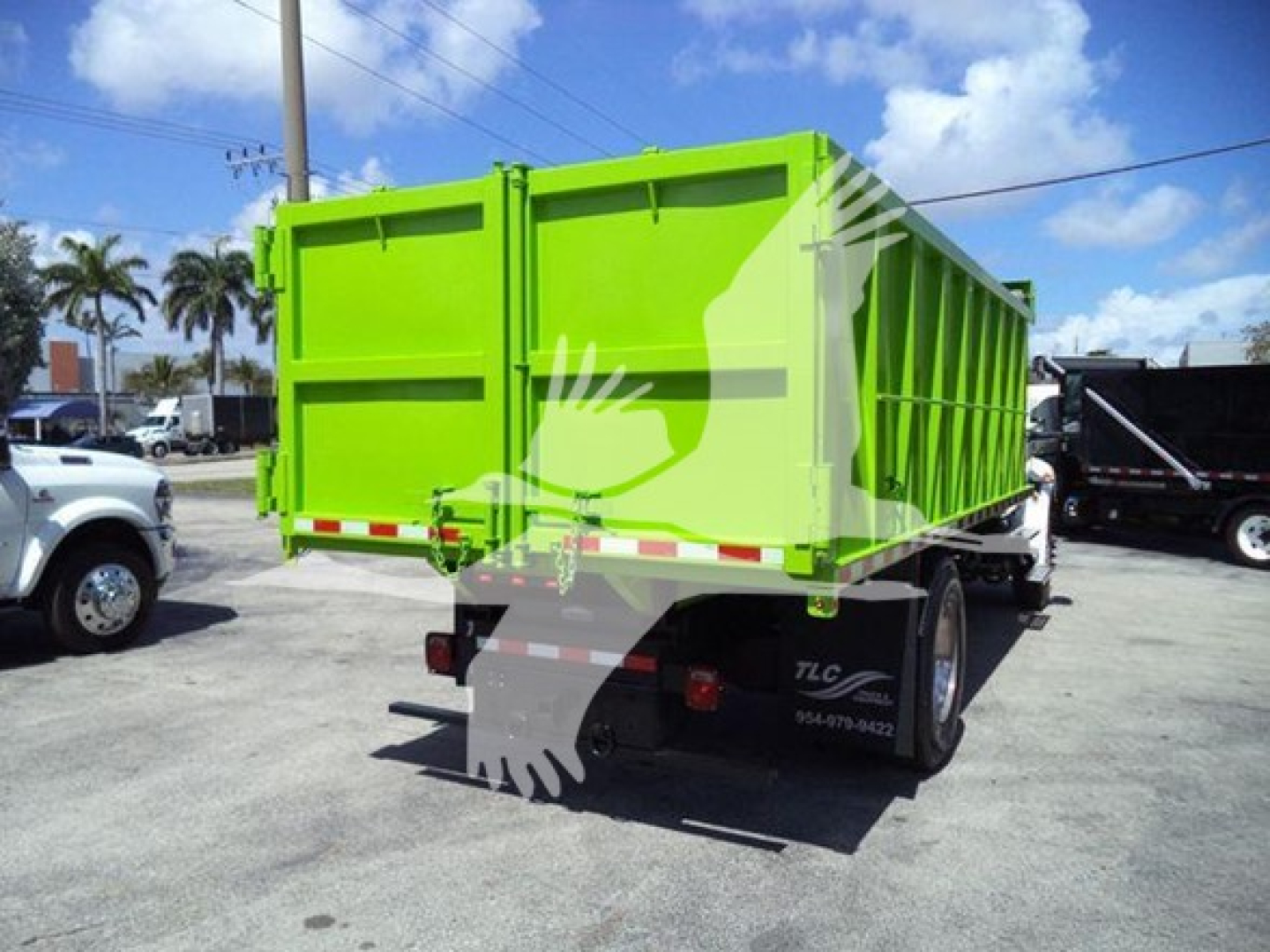Dump truck trailer showing bright green dump bed with black undercarriage and rear tailgate; text on rear includes TLC logo and contact numbers.