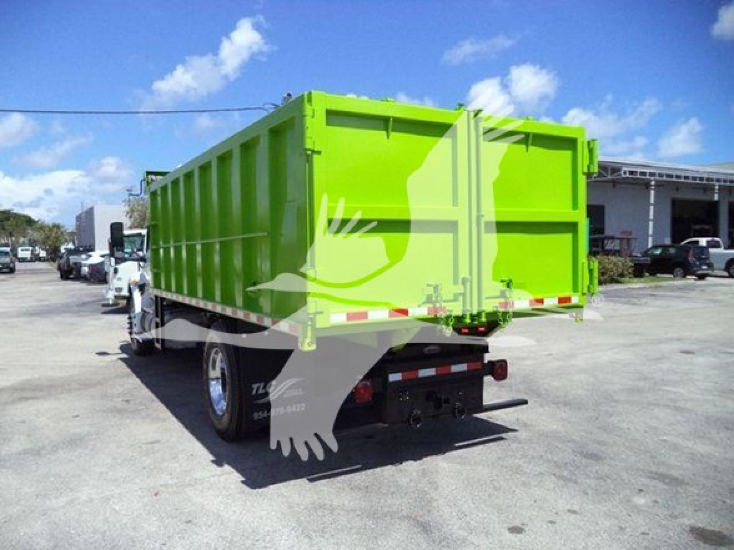 Dump truck bed in bright lime green with rear tailgate, viewed from left-rear angle; International MV chassis, stock T98791, VIN 3HAEUMML1LL198791.