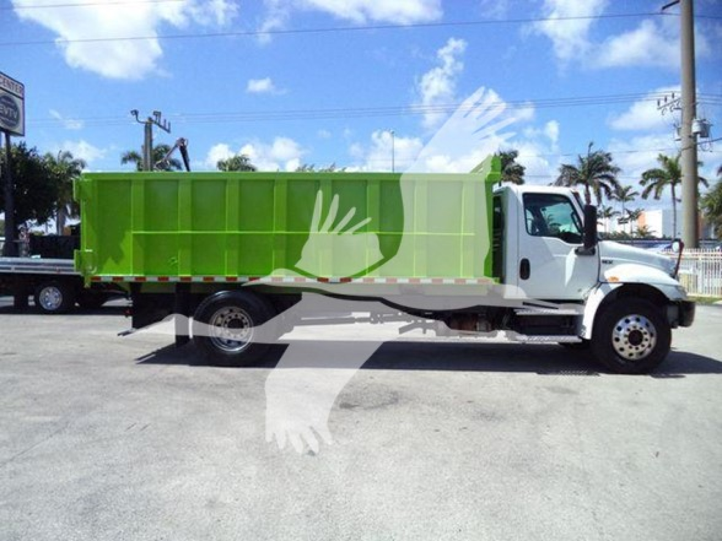 Truck side profile showing a white cab and bright green dump bed with a watermark across the image.