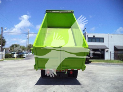 Dump truck bed of a bright green 2020 International MV rear view showing the open-top cargo box.