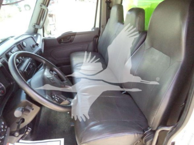 Interior of a 2020 International MV dump truck showing driver seat and passenger seat with dashboard and steering wheel.