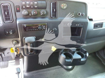 Interior of a 2020 International MV dump truck cab showing dashboard controls, cup holder, and ignition area.