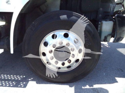 Wheel and tire assembly of a 2020 International MV dump truck showing front hub with chrome wheel and lug nuts