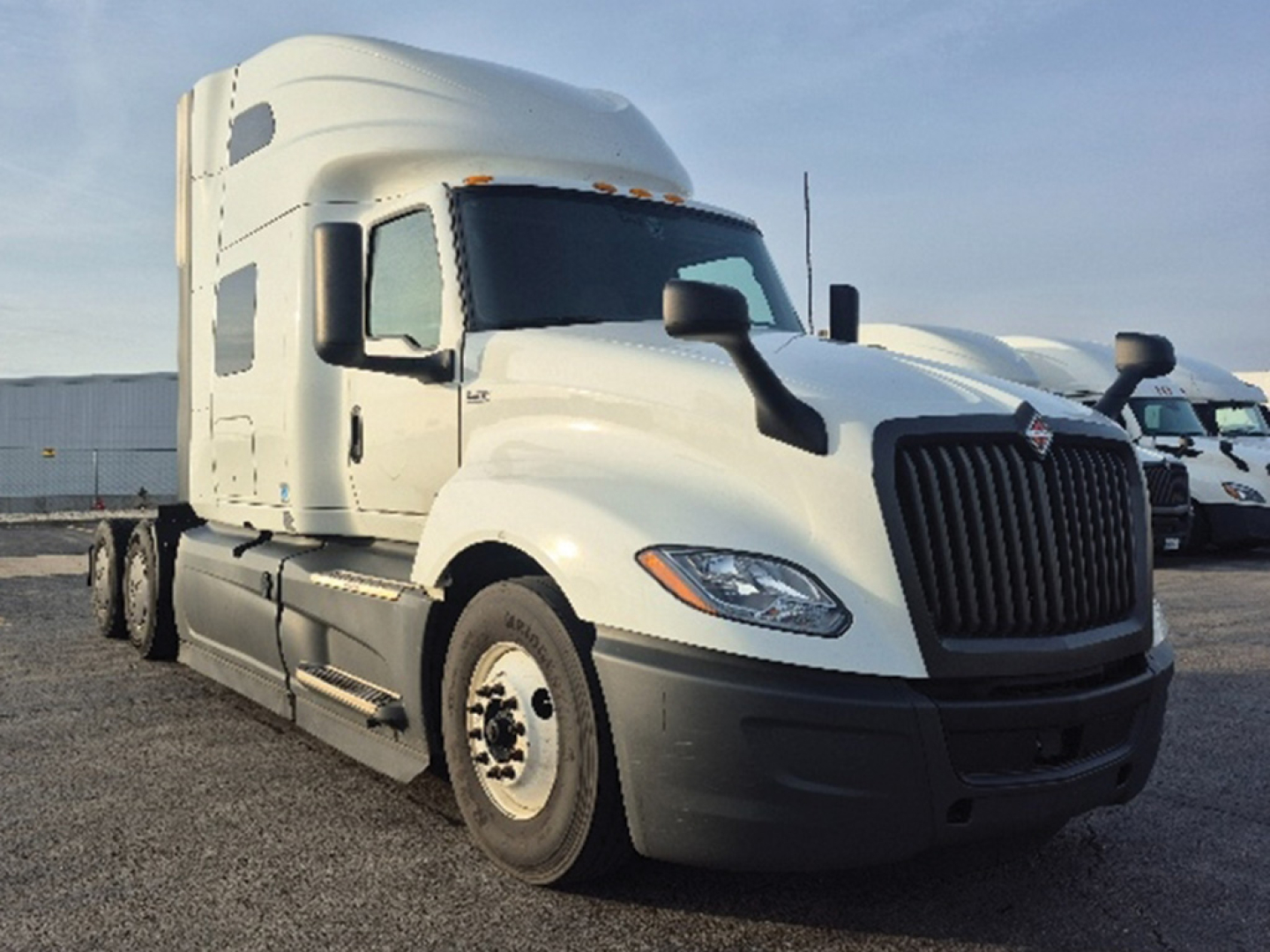 Truck: 2023 International LT625 conventional sleeper, white, front-left angled view, VIN 3HSDZAPR0PN733952