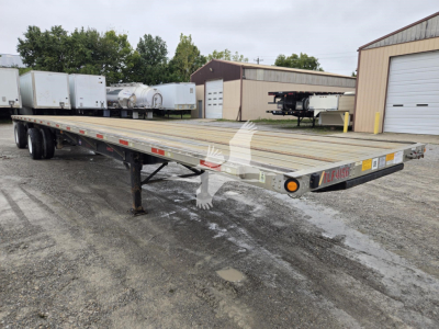 Flatbed trailer with long aluminum decking and white logo on side, VIN 1UYFS2482GA496618 on front edge. Front corner shows orange reflector and 'FL... ' markings.