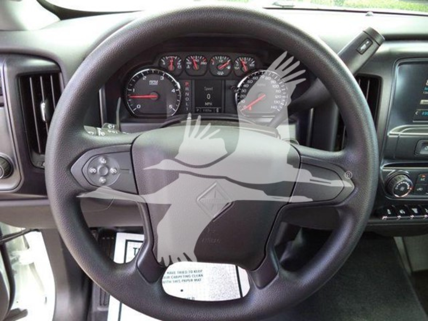 Interior close-up of a 2023 International CV truck steering wheel and instrument cluster with dashboard controls visible.