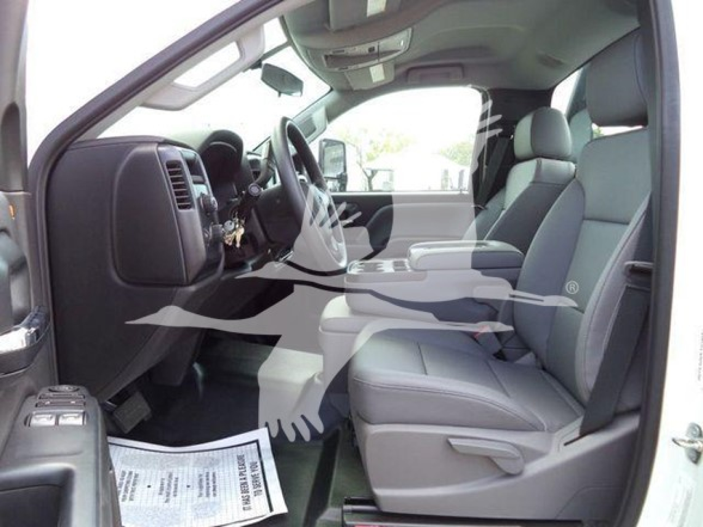 Truck cab interior in a new International CV rollback showing front seats and dashboard with steering wheel.