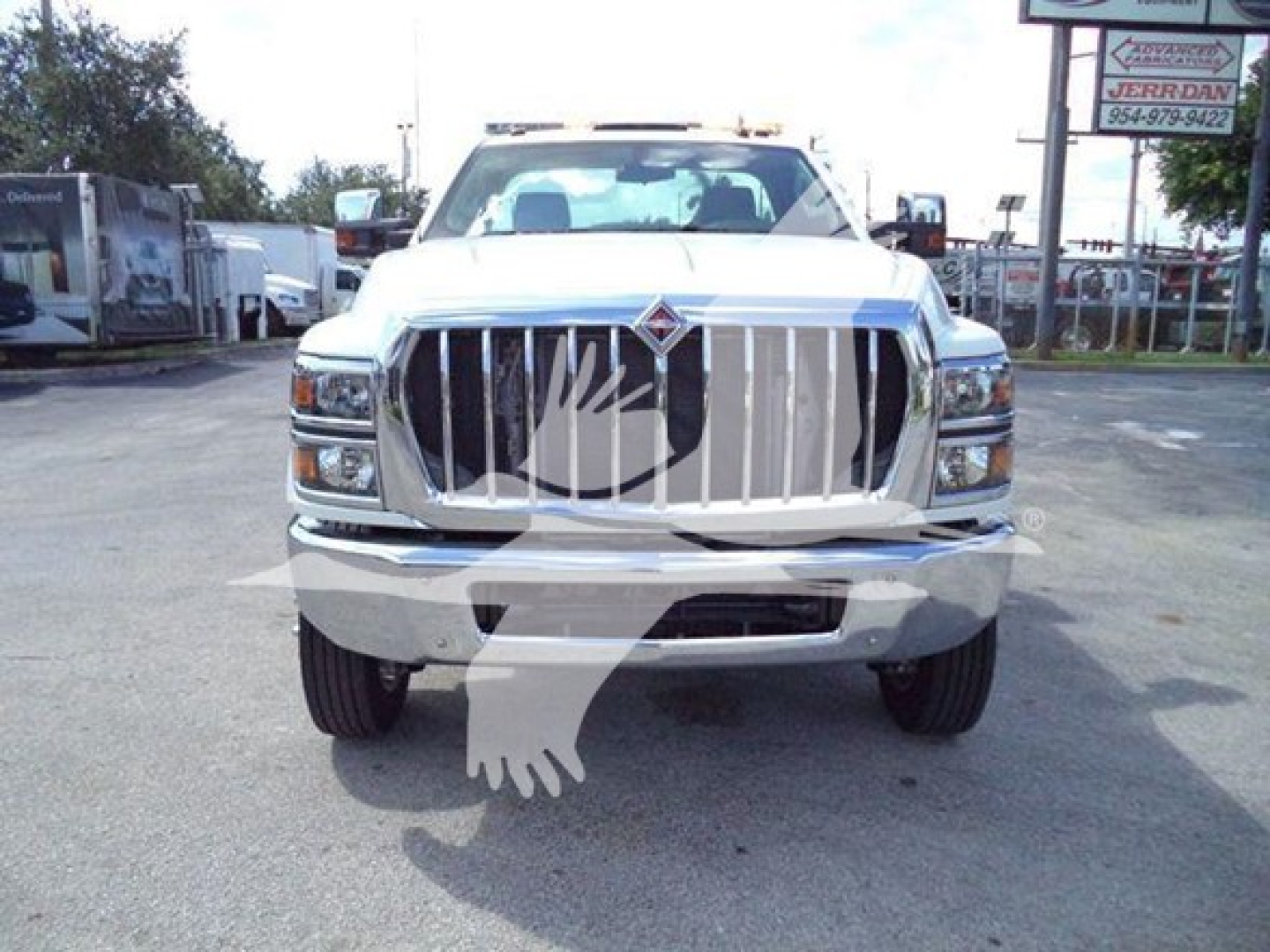 International CV truck front view showing large chrome grille and bumper.