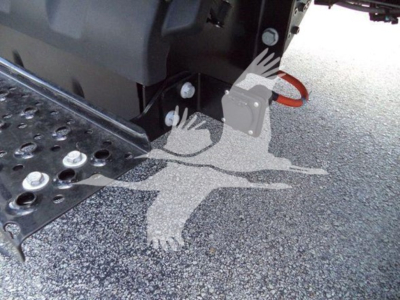 Truck rollback equipment hitch and steps visible under chassis with platform and hydraulic components