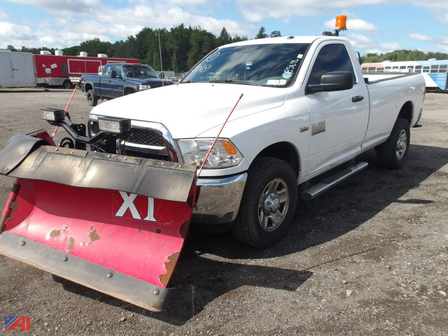 Ram pickup truck with plow attached, white 2018 model, 4x4, front view showing plow and amber beacon on cab.