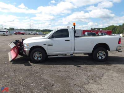 2018 Ram 2500 pickup with snow plow attachment, side view in gravel lot, white crew cab, orange beacon light on bed, RAM 2500 badge on front door.