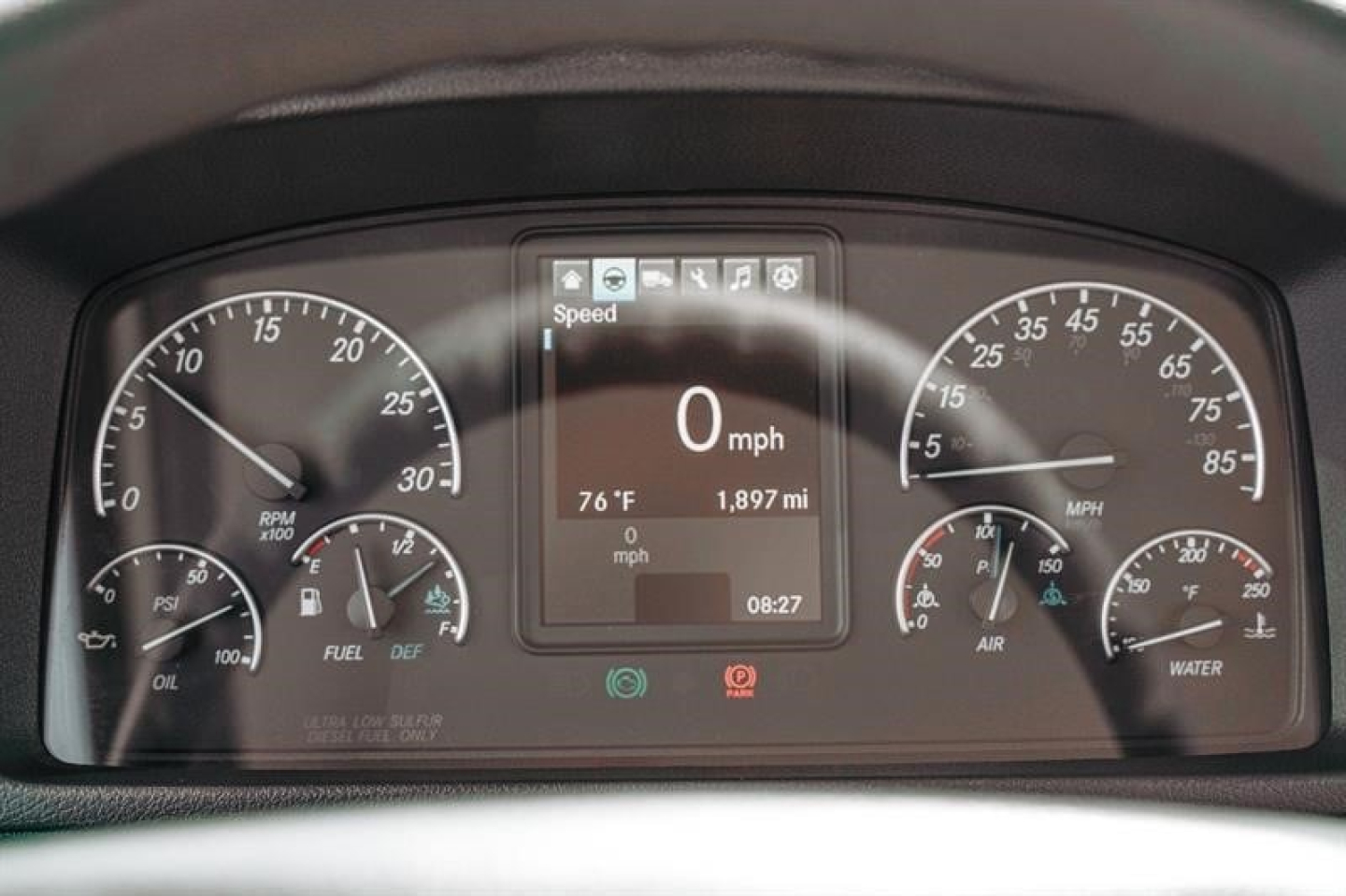 Dashboard display showing 0 mph, digital speed readout, center screen with 1,897 mi and 08:27, left gauges for RPM and fuel, right gauges for air and water, plus warning icons.
