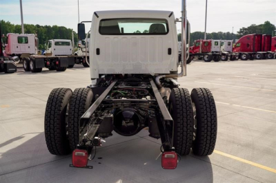 Rear view of a Freightliner M2 106 Plus cab and chassis with dual rear axles. VIN plate and stock number not visible.