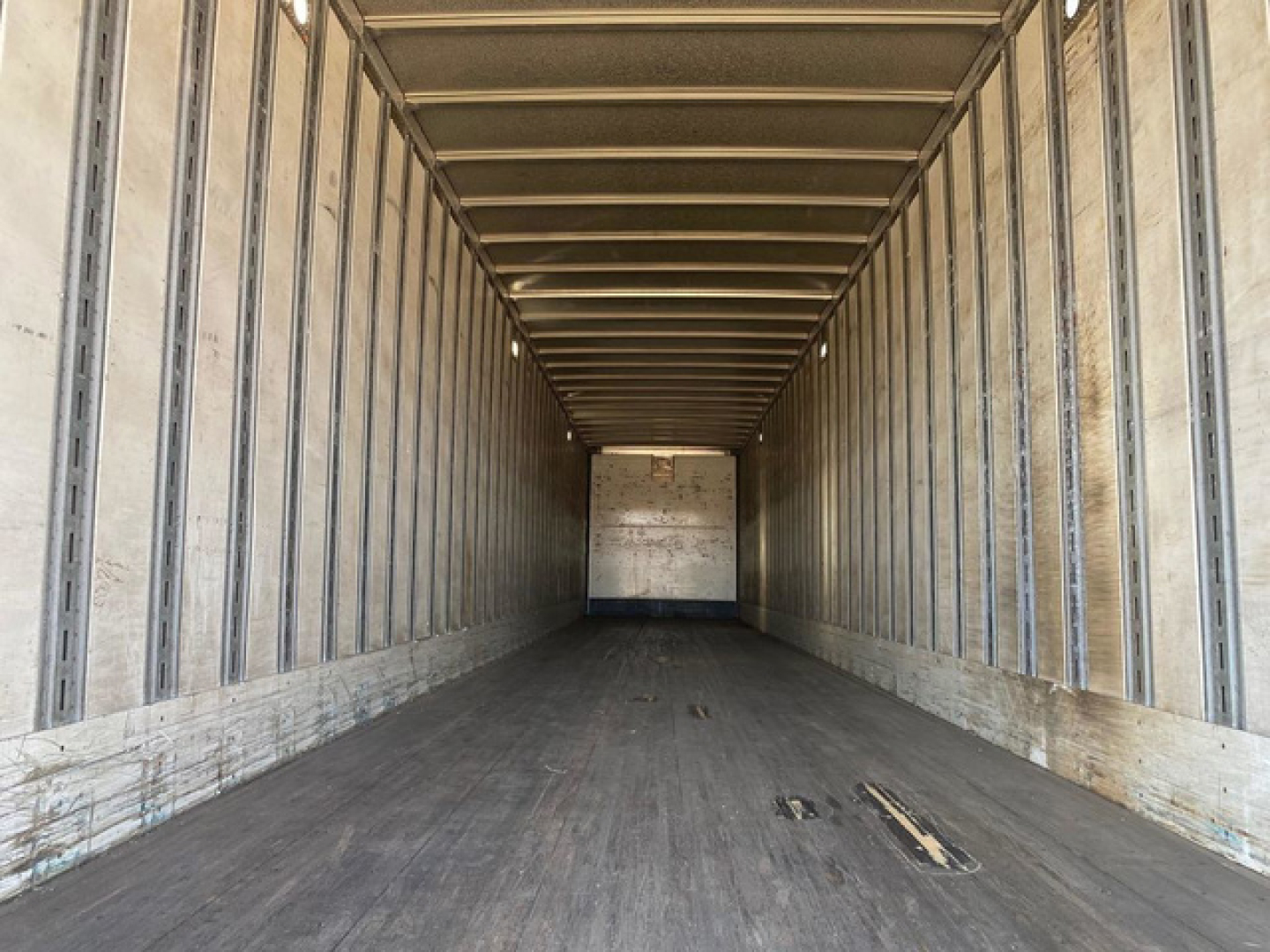 Stoughton van trailer interior showing empty cargo area with metal side rails and wooden floor. VIN 1DW1A5329ES435956 stock U90953.