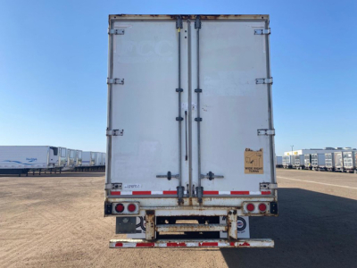 Rear view of a 2014 Stoughton van trailer showing closed double doors, rear bumper with reflective tape, and taillights.