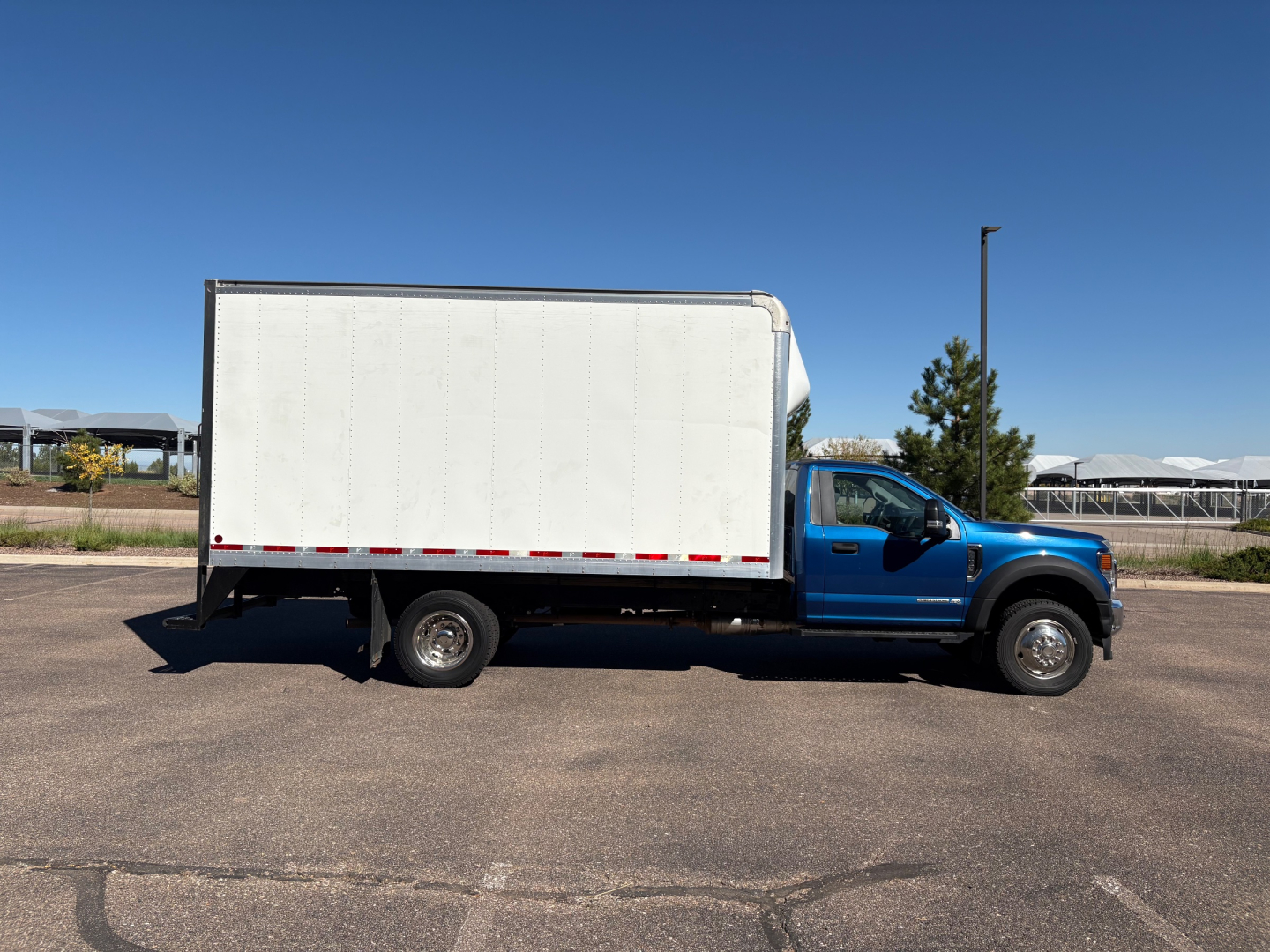Ford F-550 box truck side view showing cargo box and blue cab