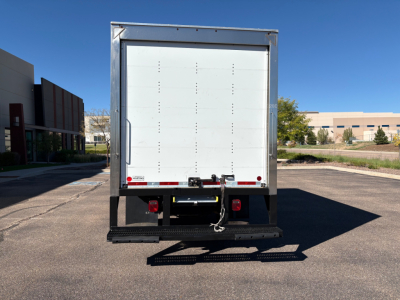Rear view of a 2022 Ford F550 box truck showing the back doors, metal frame, and bumper with a rear underride guard.