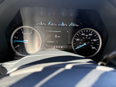 Ford F-550 dash cluster showing digital speedometer reading 0 mph, analog speedometer around 0-100 mph, gear indicator P R N D M, and odometer 107,610 miles.