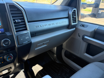 Ford Super Duty F-550 interior dashboard view showing 'SUPER DUTY' badge on passenger side and center console, with steering wheel area and HVAC controls.