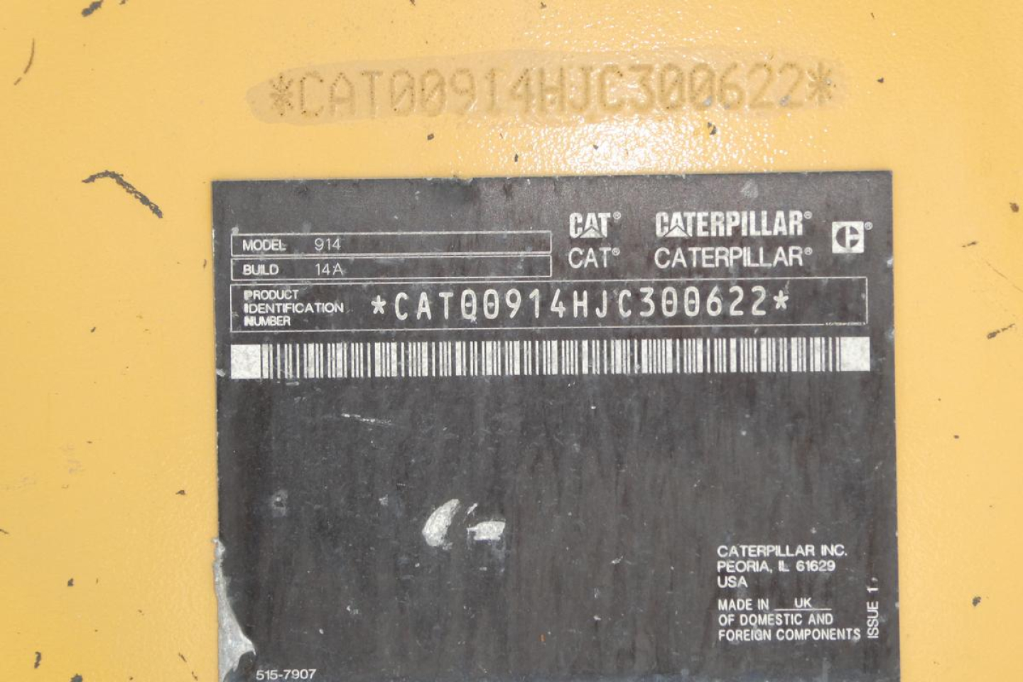 Vehicle ID plate on CAT 914 wheel loader showing model 914, build 14A, product identification number CAT00914HJC300622 and barcode area.