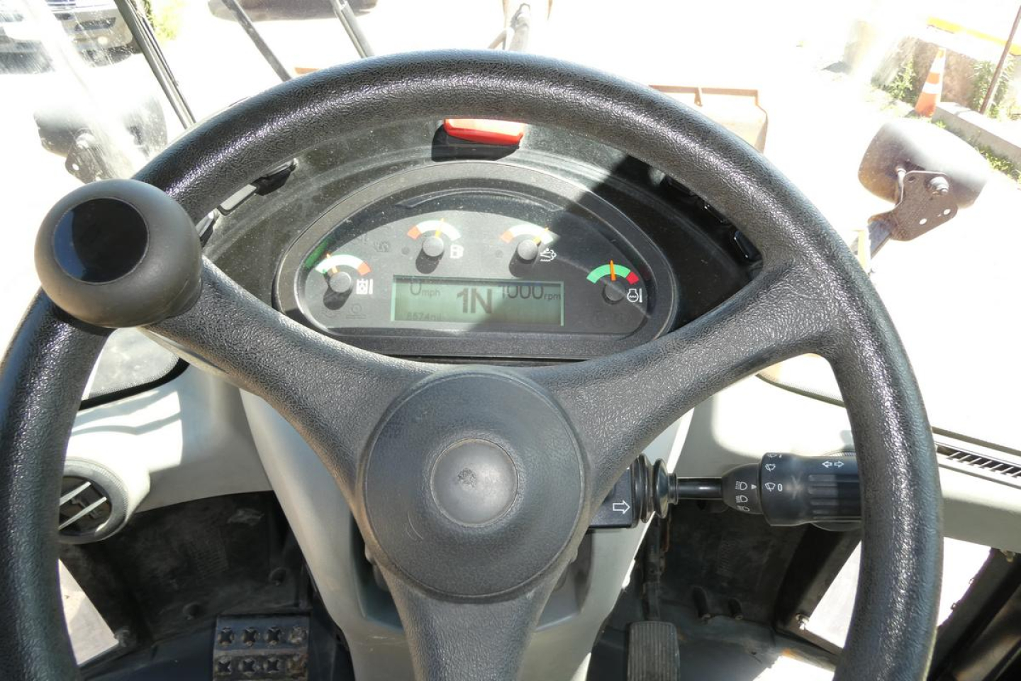 Caterpillar 914 wheel loader operator cockpit with steering wheel and instrument cluster visible