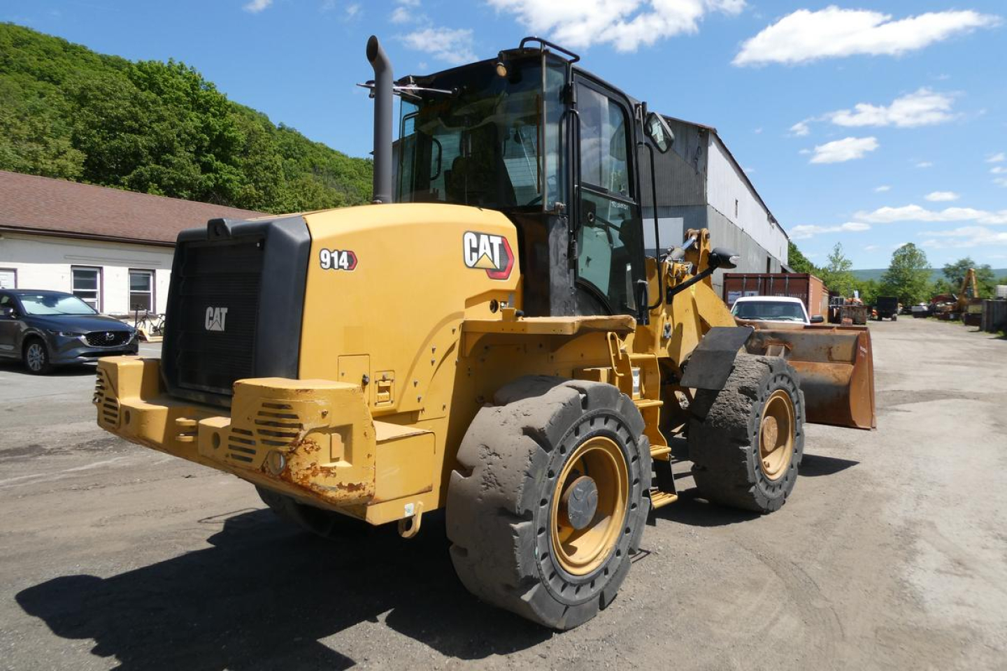 Front-left view of a yellow Caterpillar 914 wheel loader with bucket attachment, CAT logo, and model number 914 visible on the body.