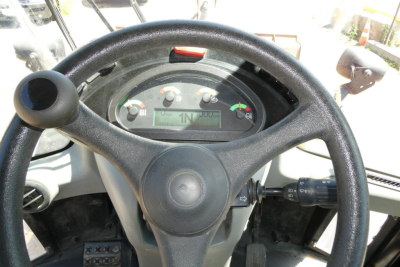 Caterpillar 914 wheel loader operator cockpit with steering wheel and instrument cluster visible