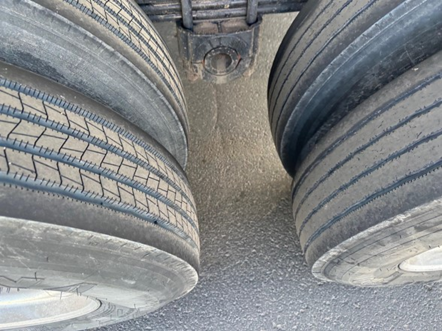 Two rear dual tires of a Load King frameless rock end dump trailer showing tread details and spacing between wheels