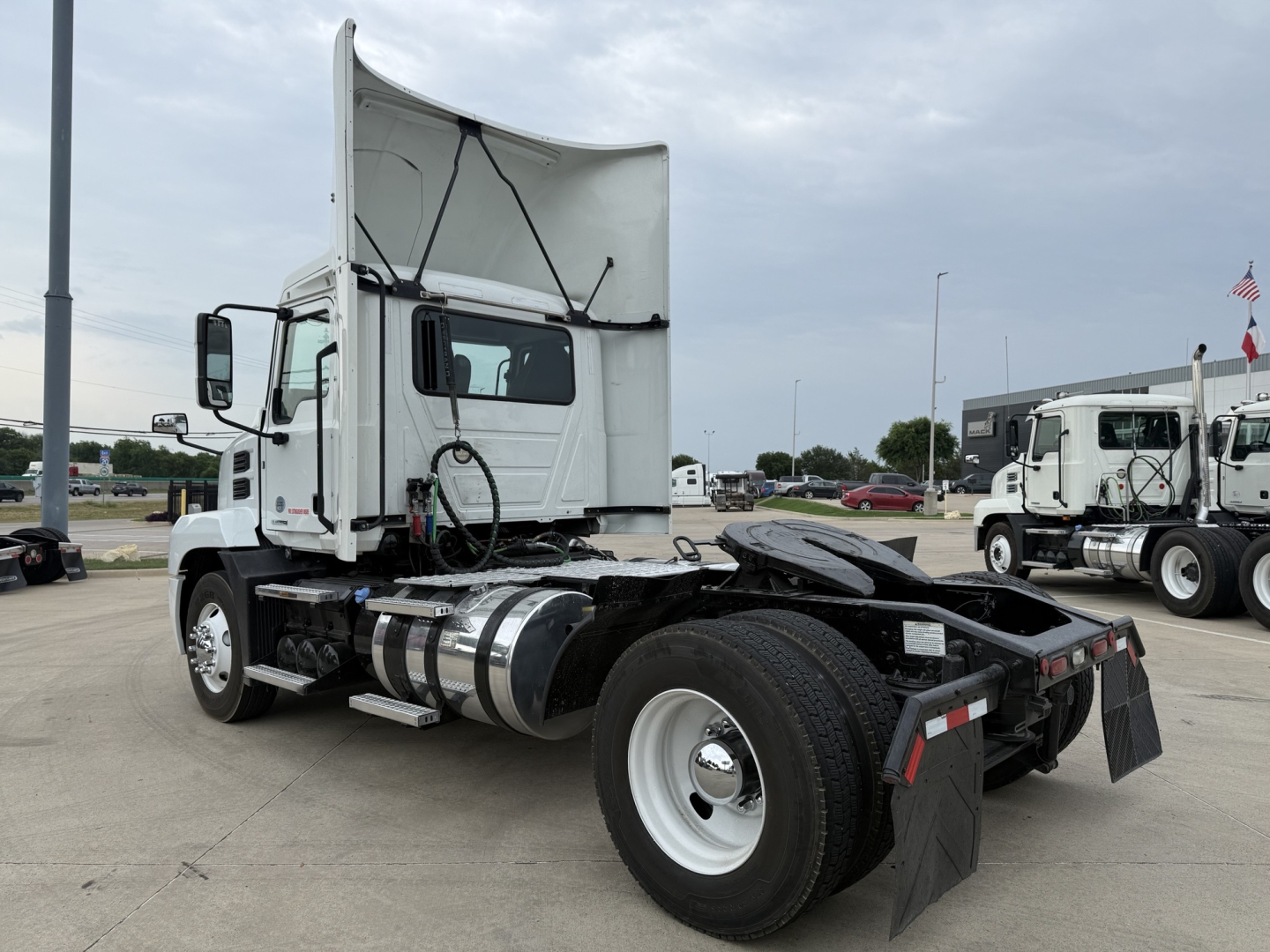 Truck chassis and cab of a 2022 Mack AN42T daycab. Side view shows fuel tanks, rear chassis, and mud flaps.