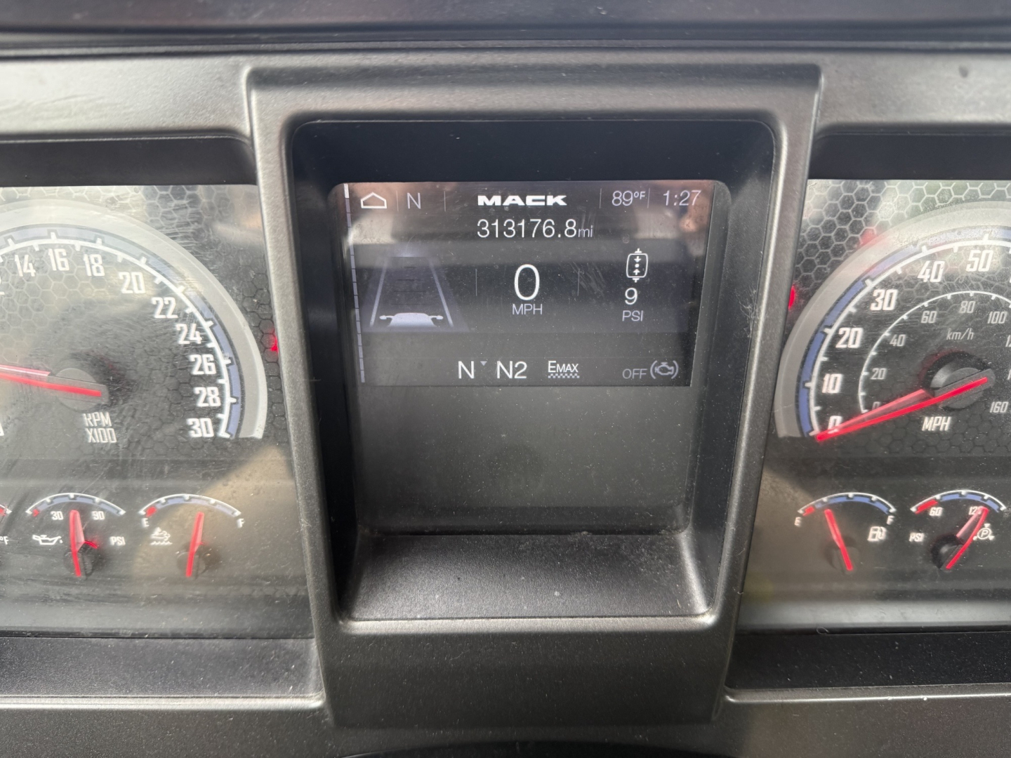 Mack AN42T dash cluster showing Digital display with 0 MPH, gauges on left and right, and VIN/stock information panel above.