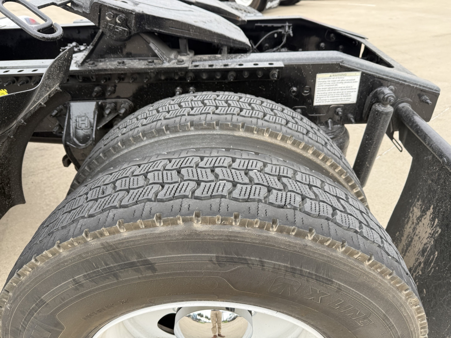 Mack AN42T truck chassis showing dual rear tires and undercarriage components.