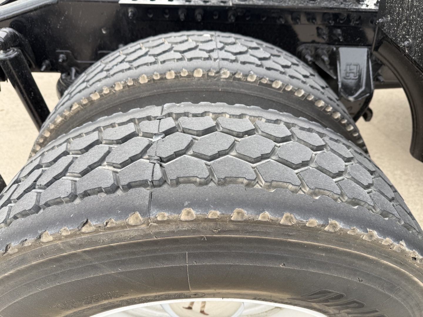 Front dual rear tires on Mack AN42T truck showing tread pattern and sidewall details.