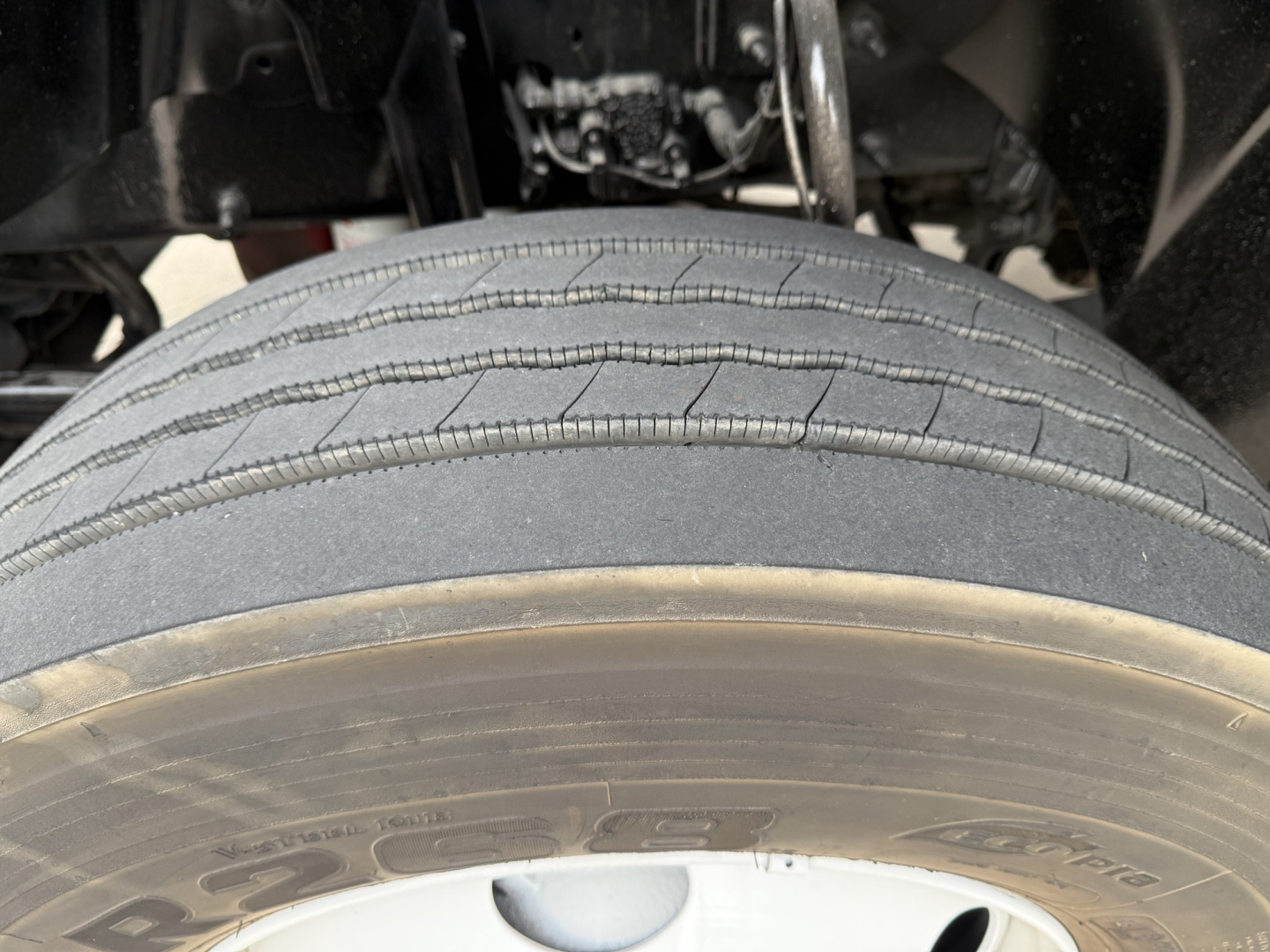 Tire close-up on Mack AN42T cab-over truck showing tread detail and wheel hub.