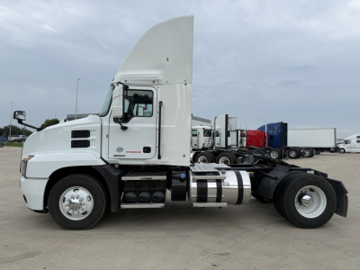 Truck side view of a 2022 Mack AN42T day cab showing fuel tanks, chassis, and cab; no visible labeling legible on cab panels in this shot.