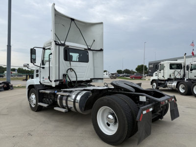 Truck chassis and cab of a 2022 Mack AN42T daycab. Side view shows fuel tanks, rear chassis, and mud flaps.