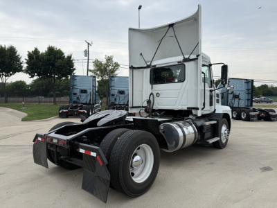 Mack AN42T daycab tractor showing rear and left side with hood raised, dual rear axles, fuel tanks, and mudflaps.