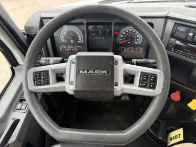 Mack AN42T truck interior showing steering wheel with Mack logo, instrument cluster, and center stack; visible gauges and controls.