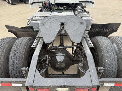 Tractor trailer fifth wheel area and rear axle of a 2022 Mack AN42T daycab showing dual rear wheels and drive axle housing.
