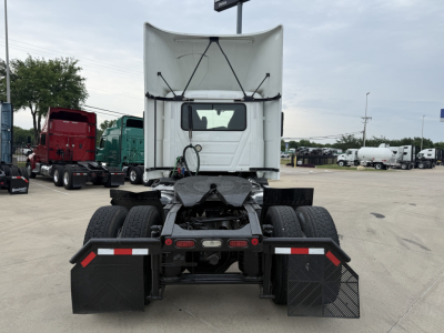 Truck rear view of a 2022 Mack AN42T daycab showing fifth wheel, rear lights, mudflaps, dual rear axles, and exhaust components.